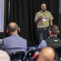 Speaker presenting on stage at Reliable Plant 2026